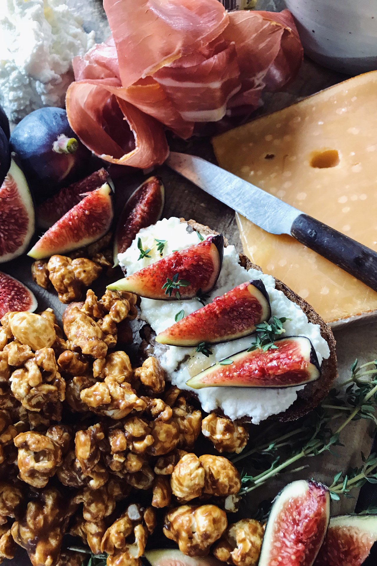 Cheese platter with almonds and figs.